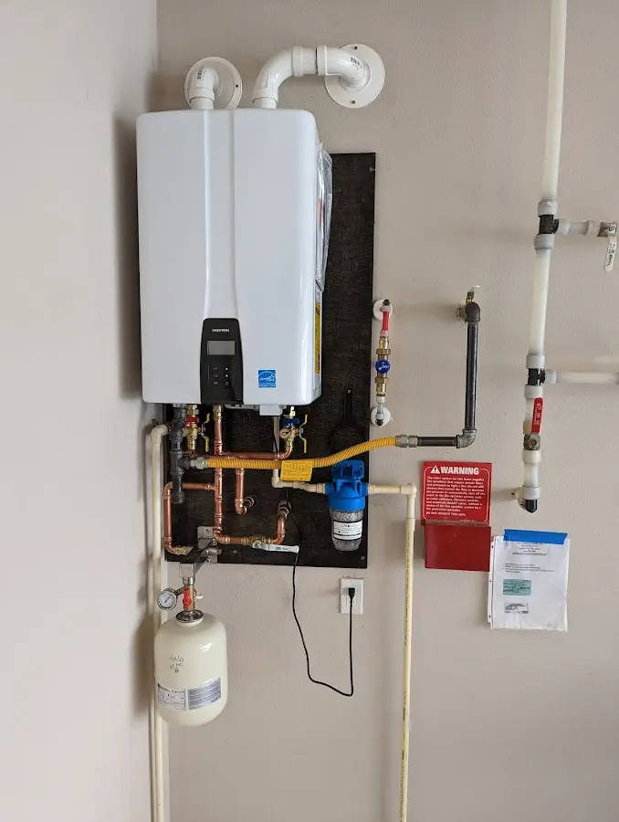 Professional plumber installing copper piping in a Centreville home